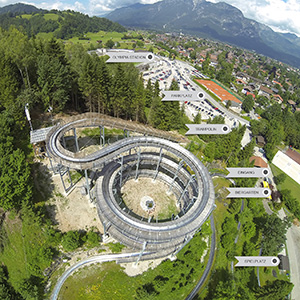 Summer toboggan run with curves and riders