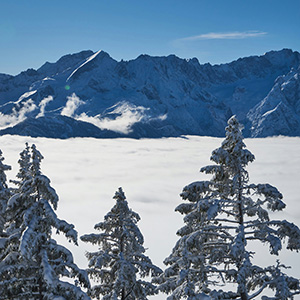 Winter landscape with skiers and snow‑covered mountains